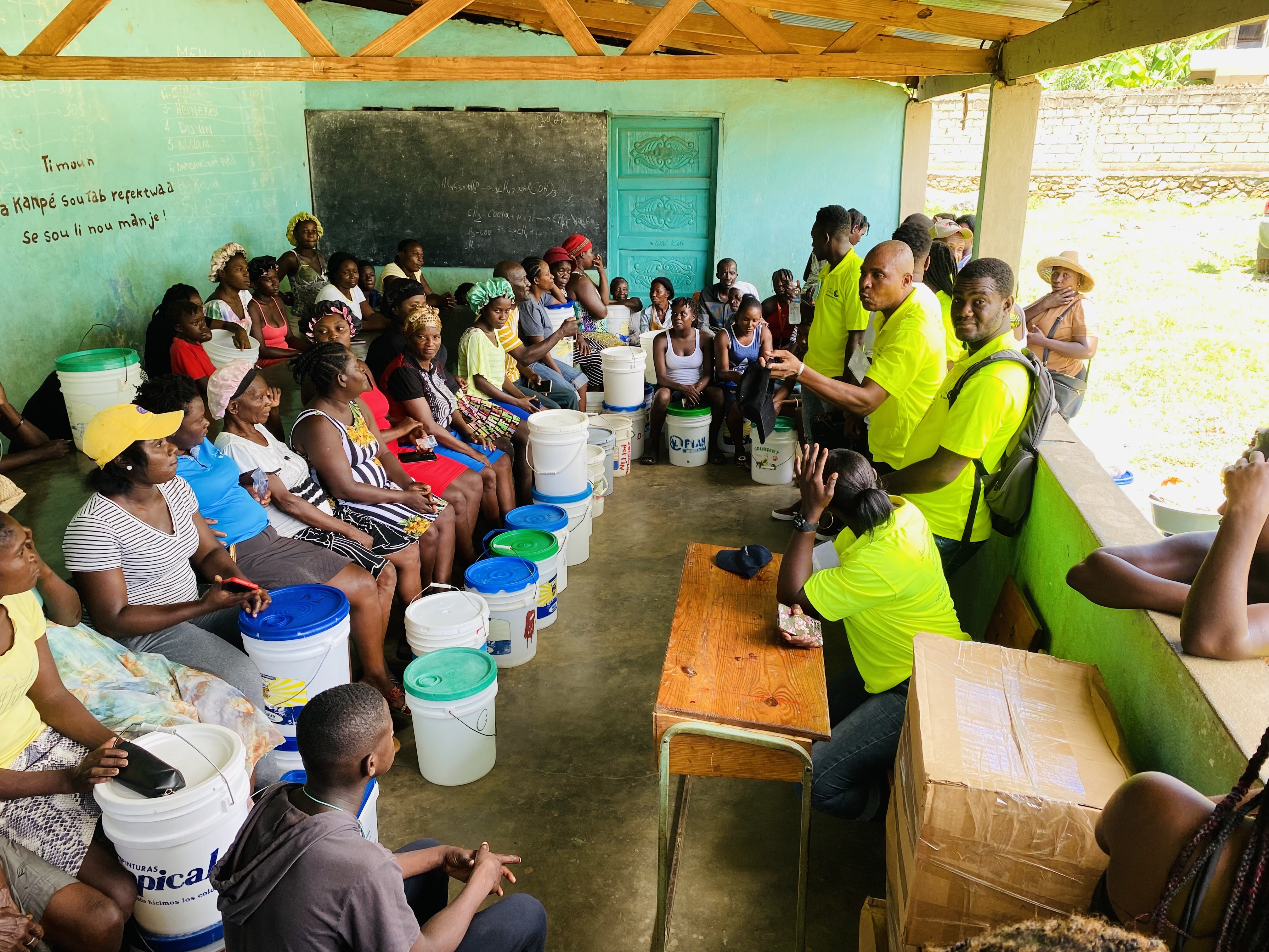 Team talking to villagers about how the distribution and training will be done