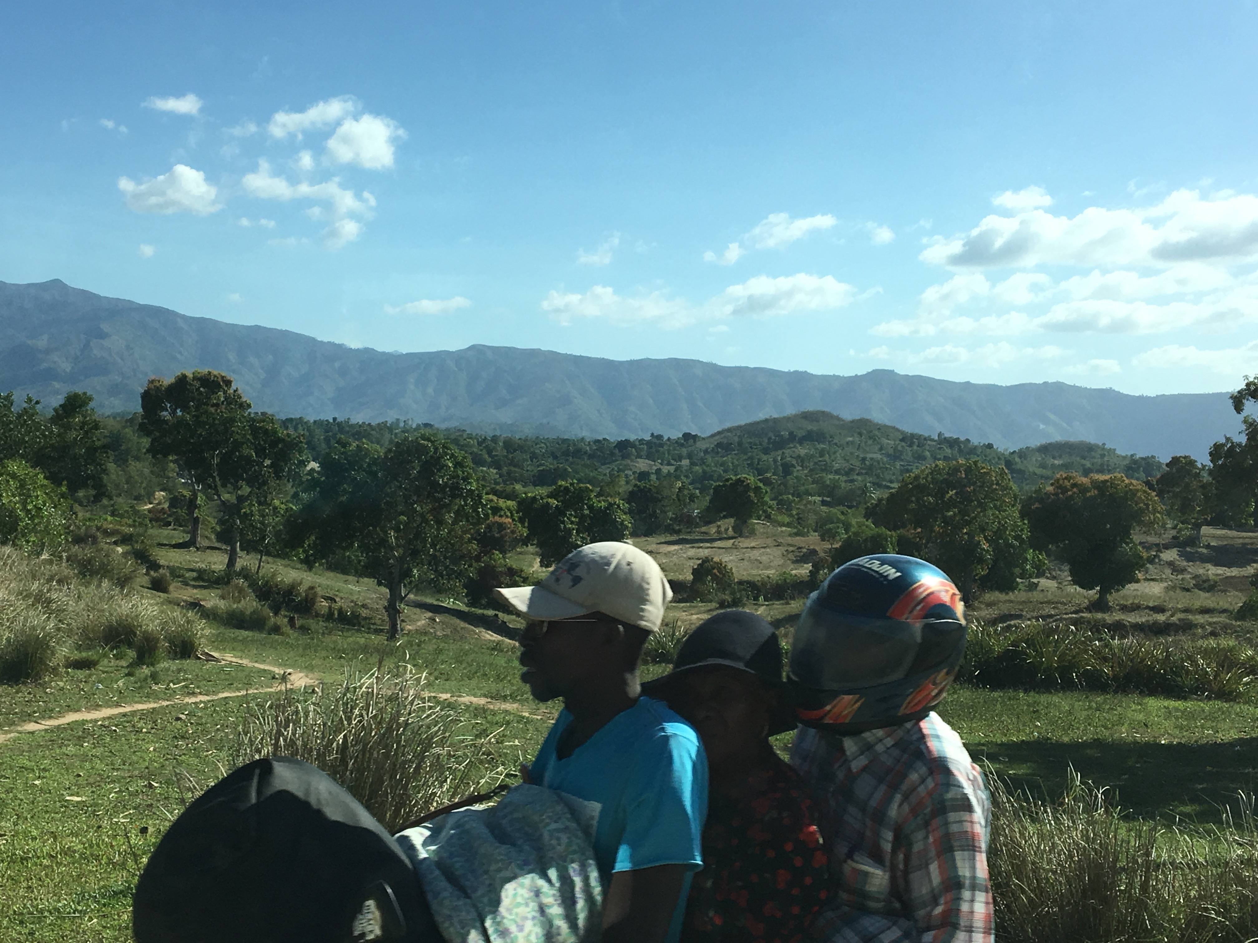 Beautiful countryside, with the hills off in the distance. Small motorcycles are a common mode of transportation in Haiti. I have seen a father with six kids arrive at the school. "There's always room for one more."