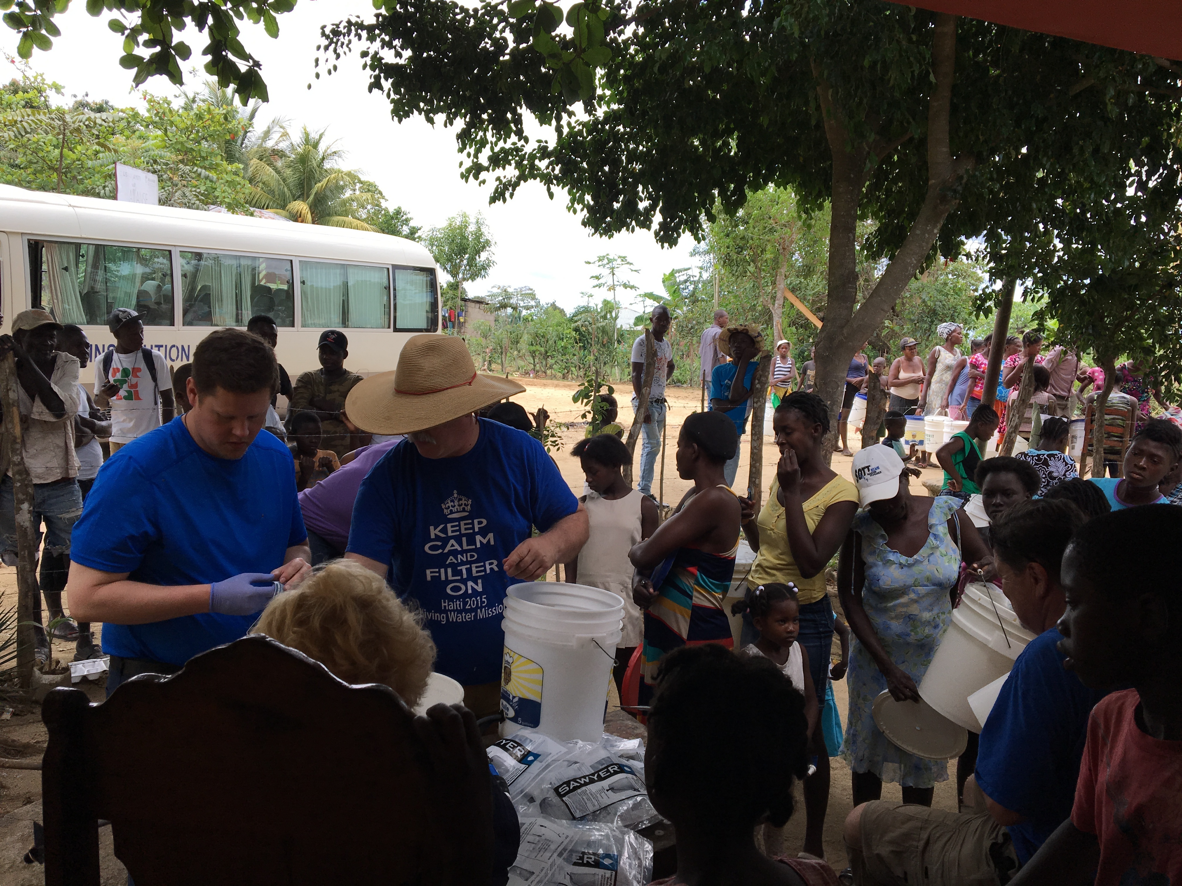 Set-up in front of a villagers house, installing and training people to use their new filters.